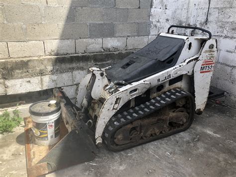 how to put track back on mini skid steer|skid steer track back on track.